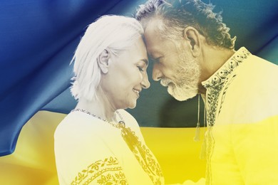 Image of Double exposure of happy mature couple wearing national clothes and Ukrainian flag