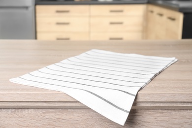 Napkin on wooden table in kitchen. Mockup for design