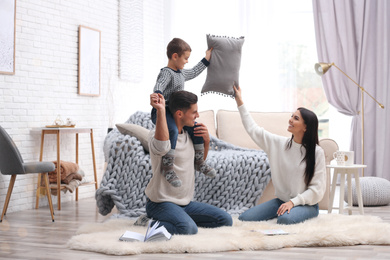 Photo of Happy family with little son having fun at home. Winter vacation