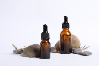 Photo of Composition with bottles of cosmetic serum on white background
