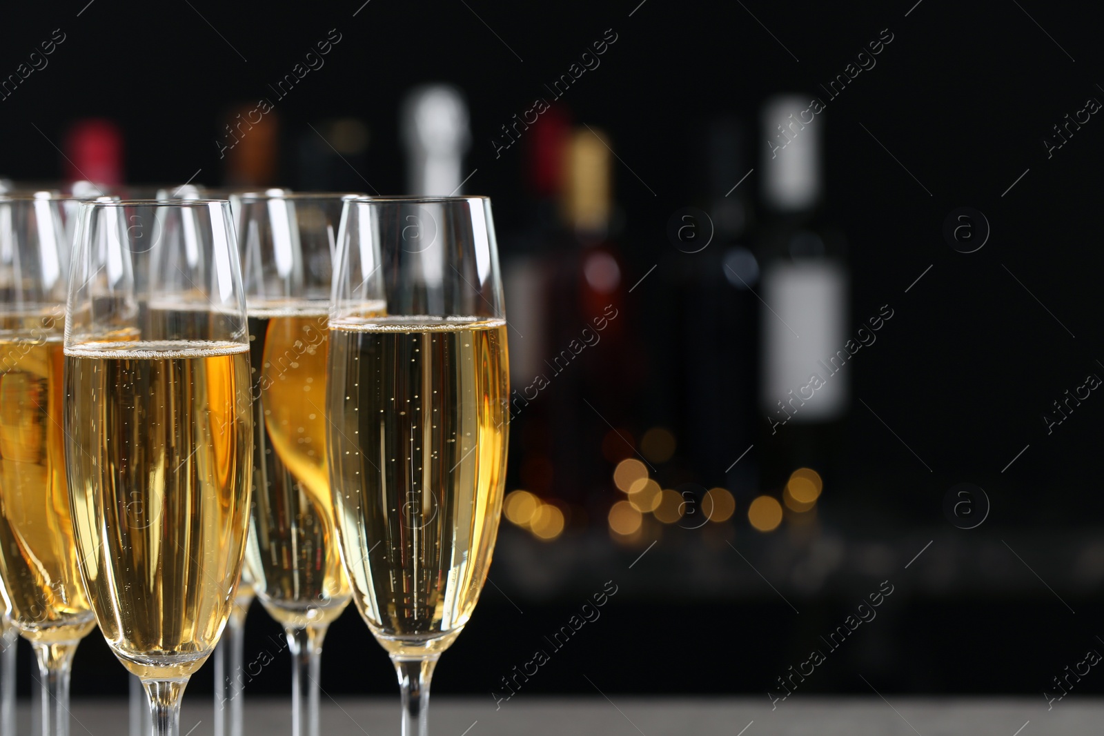 Photo of Many glasses of champagne on blurred background, closeup