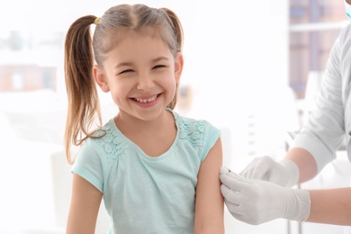 Photo of Doctor vaccinating little girl in hospital