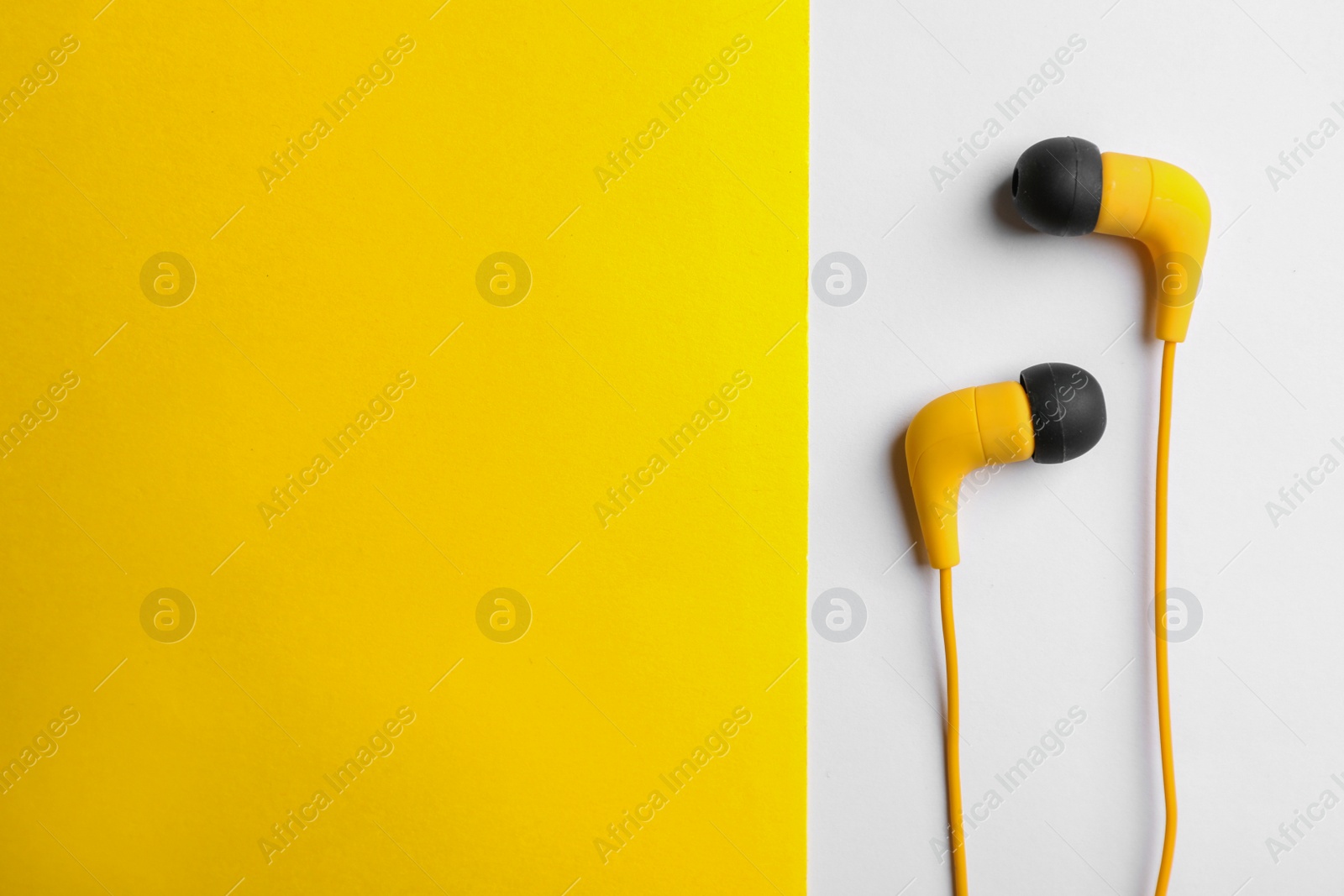 Photo of Stylish headphones on color background, top view. Space for text