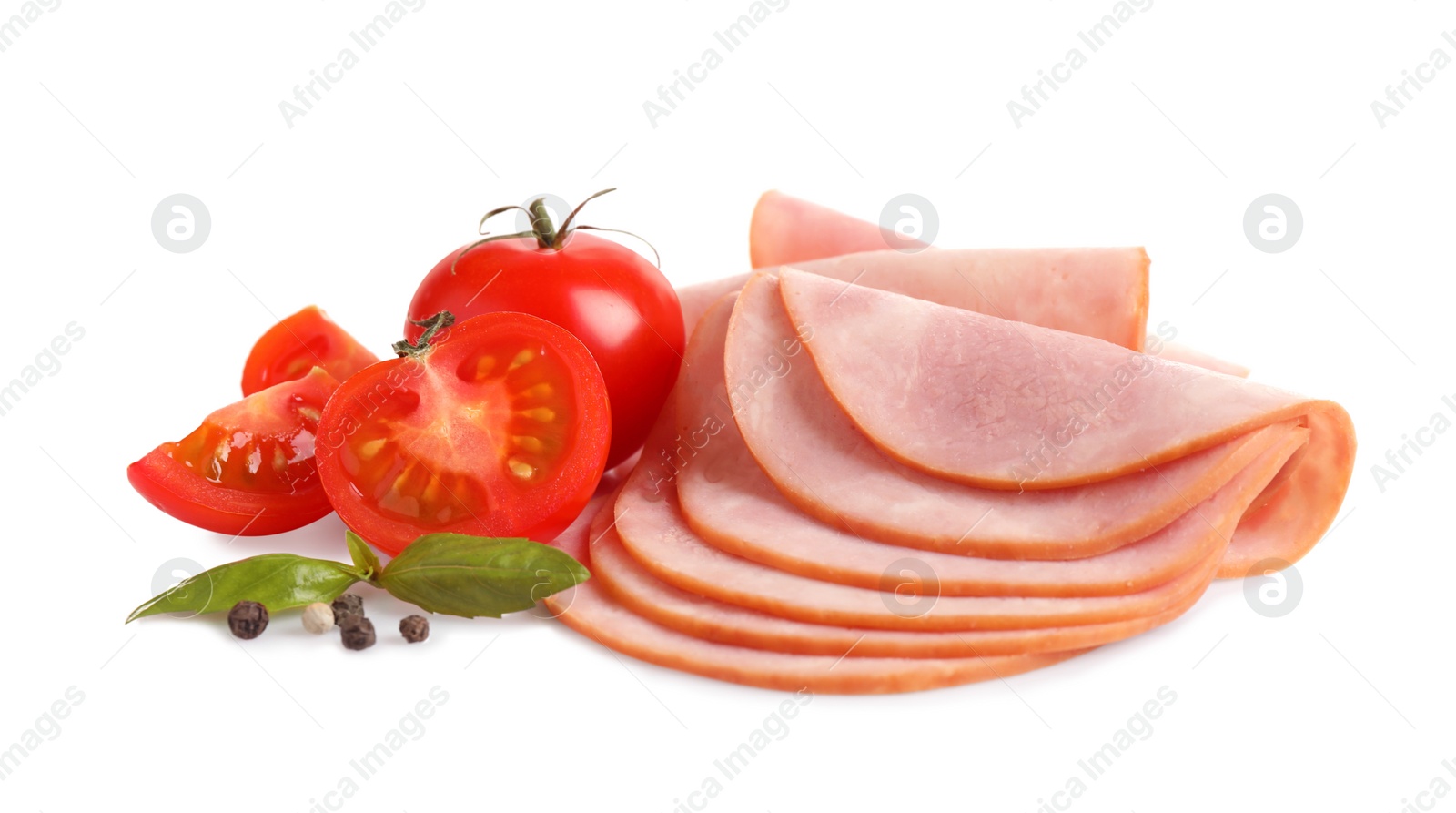 Photo of Slices of tasty fresh ham with basil, tomatoes and pepper isolated on white