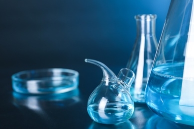 Laboratory glassware with liquid on table, space for text. Solution chemistry