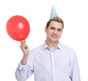 Young man with party hat and balloon on white background