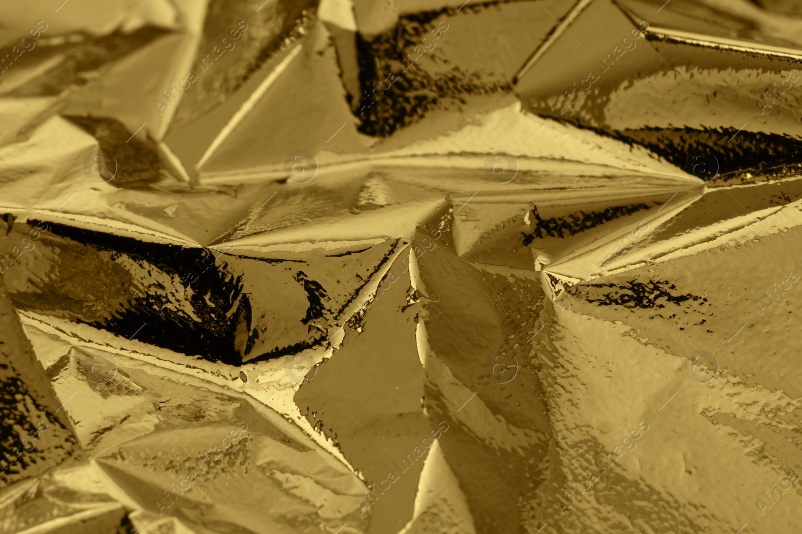 Photo of Edible gold leaf sheet as background, closeup