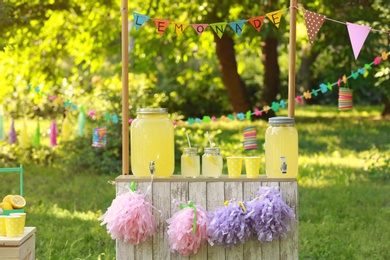 Photo of Decorated lemonade stand in park. Summer refreshing natural drink