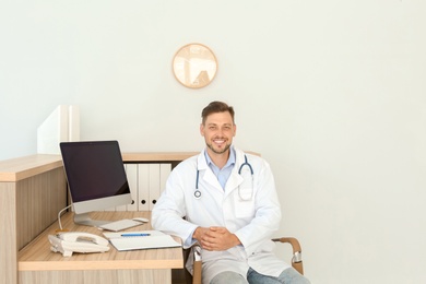 Photo of Male medical assistant at workplace in clinic. Health care service