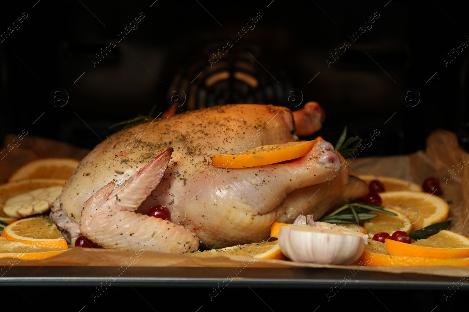 Photo of Chicken with orange slices baking in oven