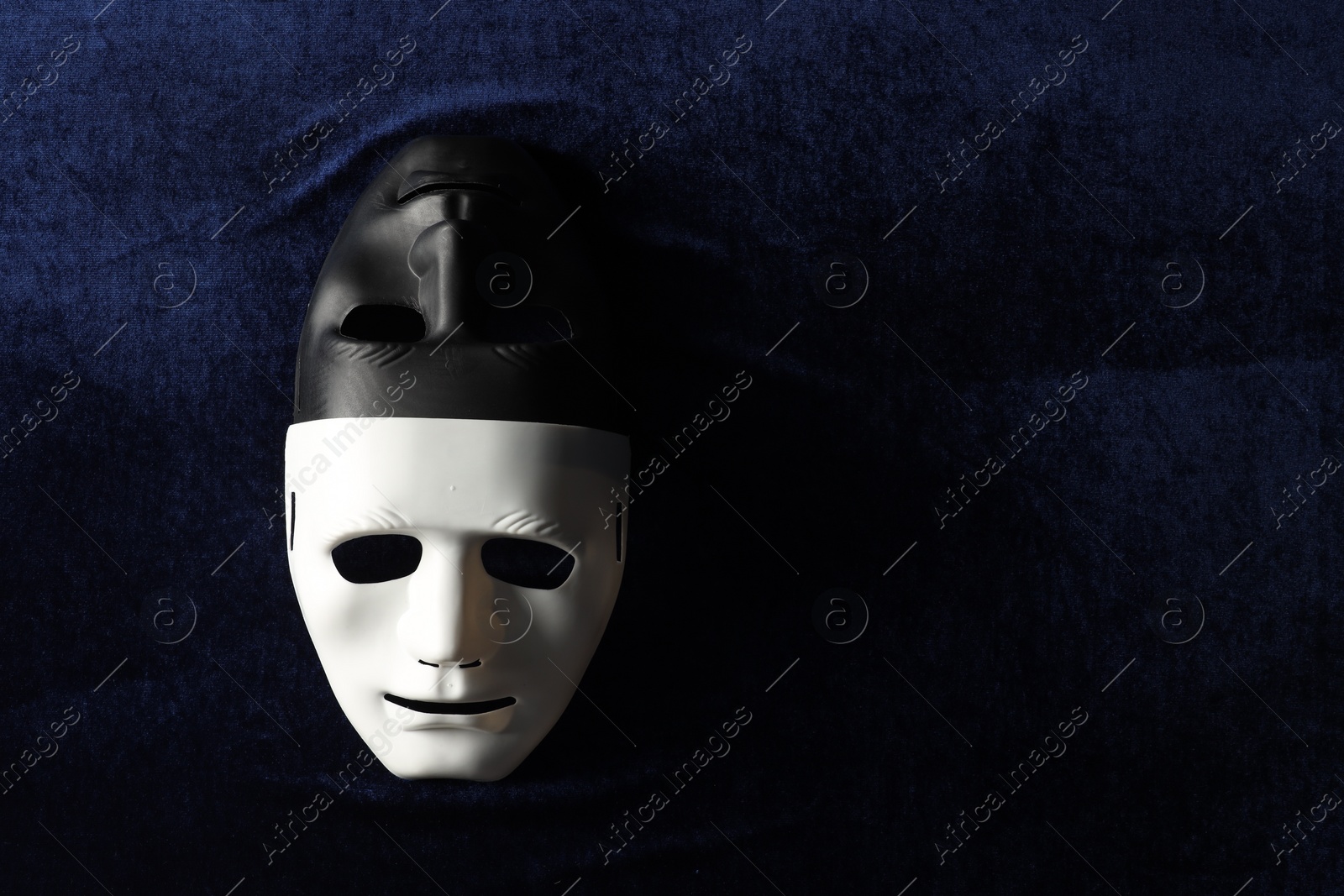 Photo of Theater arts. Two masks on blue fabric, top view. Space for text