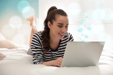 Image of Young woman visiting dating site via laptop indoors