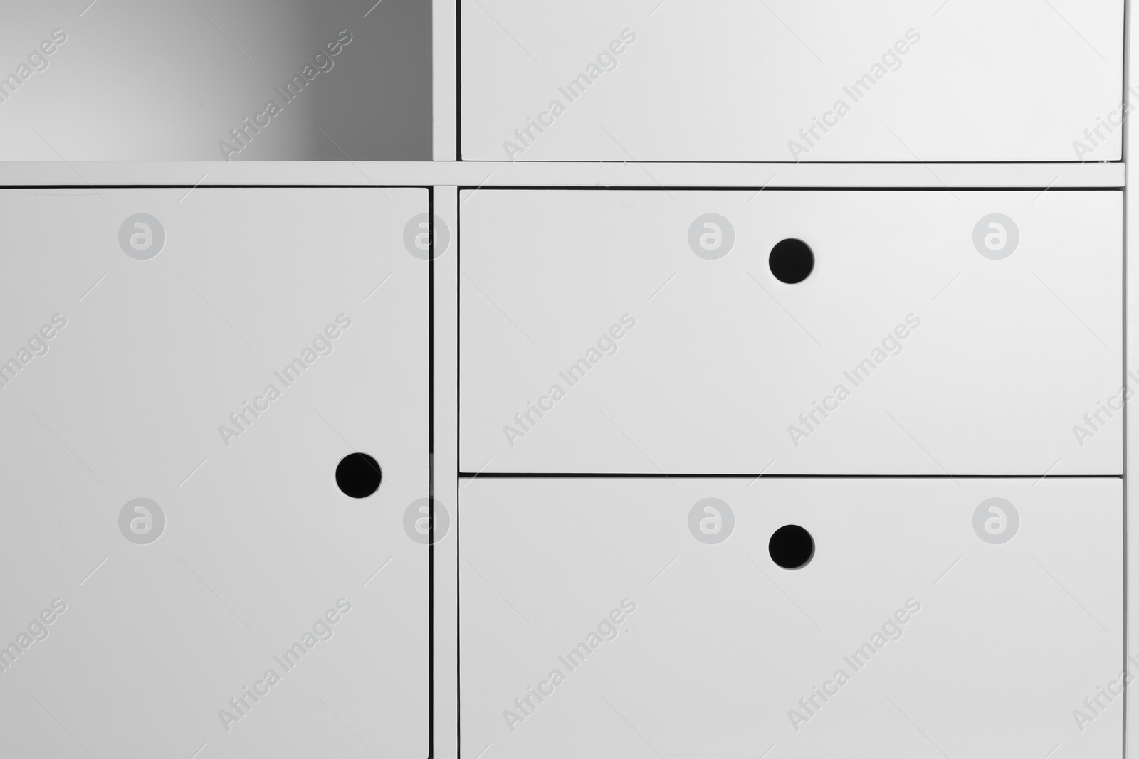 Photo of White wardrobe compartments as background, closeup view