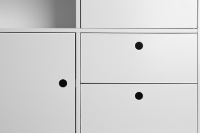 Photo of White wardrobe compartments as background, closeup view