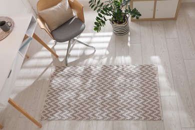 Photo of Stylish rug with pattern on floor in room, above view