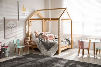 Photo of Cute chairs with bunny ears in children's bedroom interior