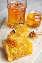 Image of Tasty fresh honey and bees on white board, closeup