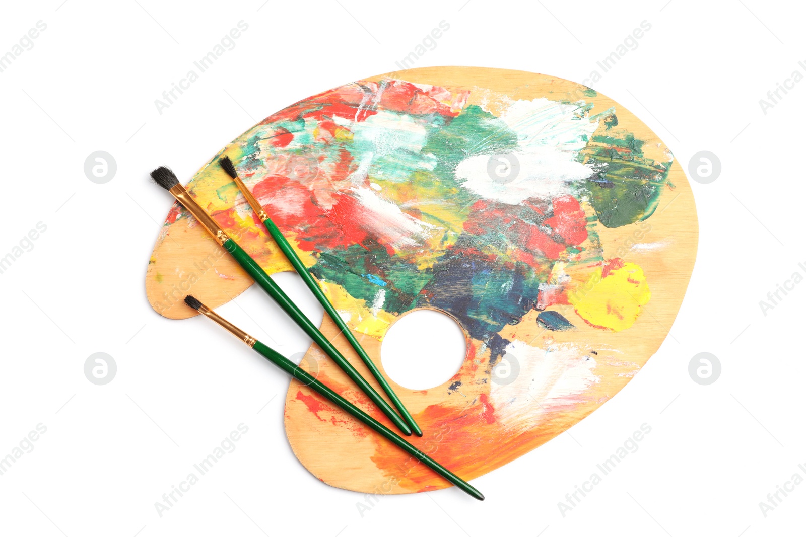 Photo of Wooden palette with brushes on white background, top view. Painting equipment for children