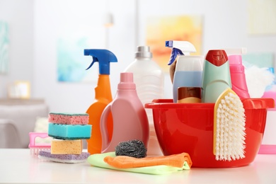 Photo of Set of cleaning supplies on table indoors