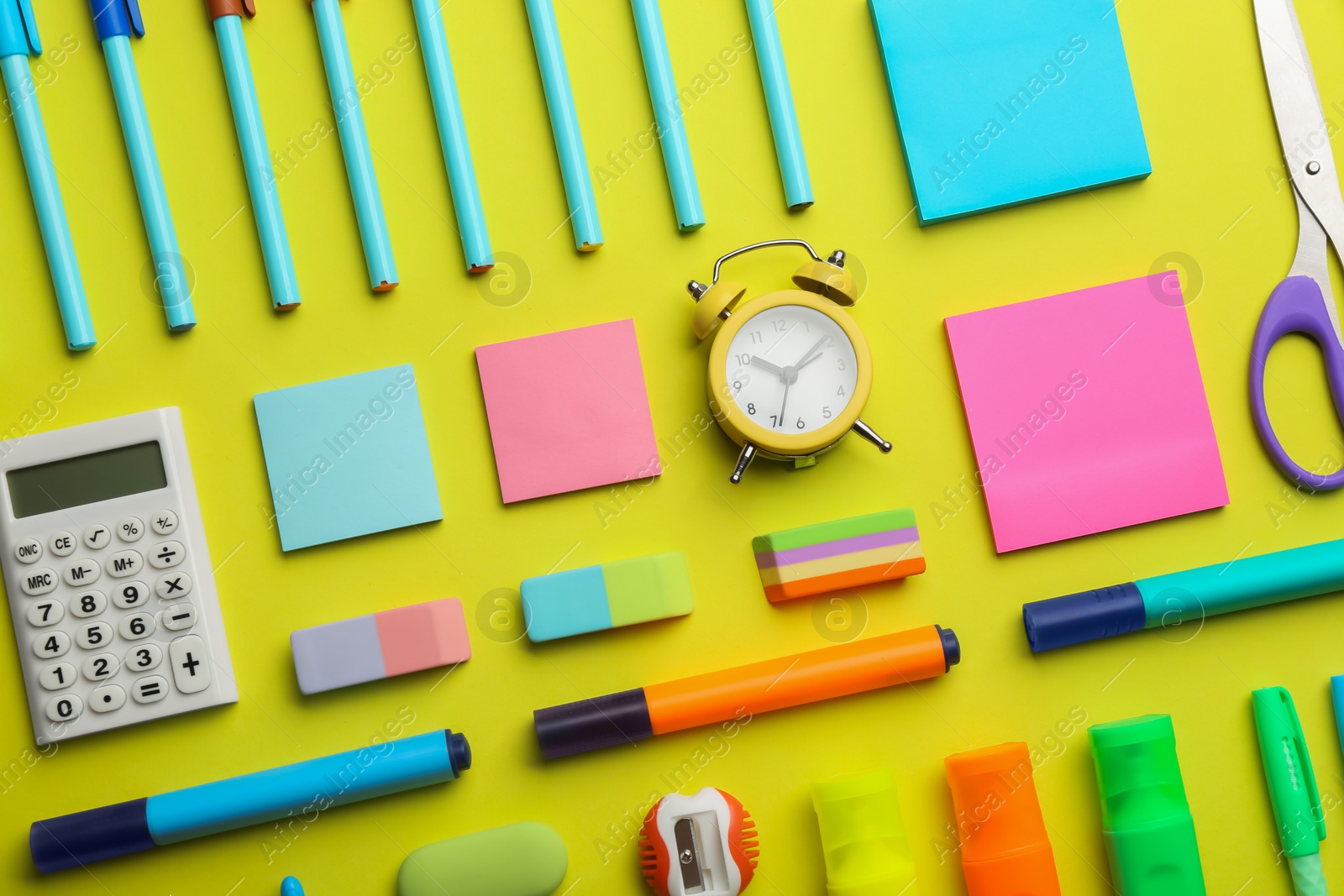Photo of Flat lay composition with school stationery on yellow background. Back to school