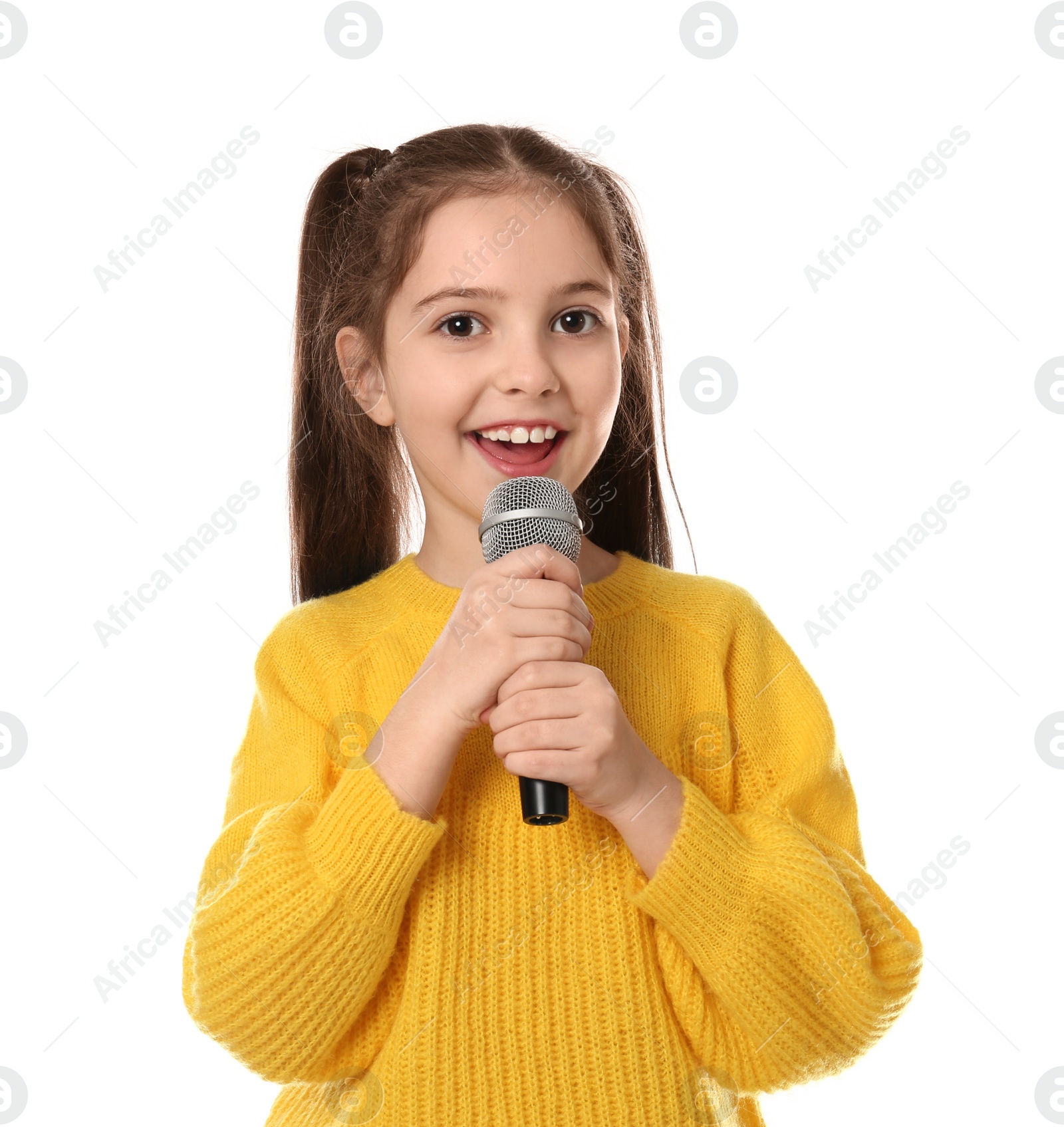 Photo of Little girl singing into microphone on white background