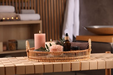 Beautiful composition with different spa products on wicker bench indoors