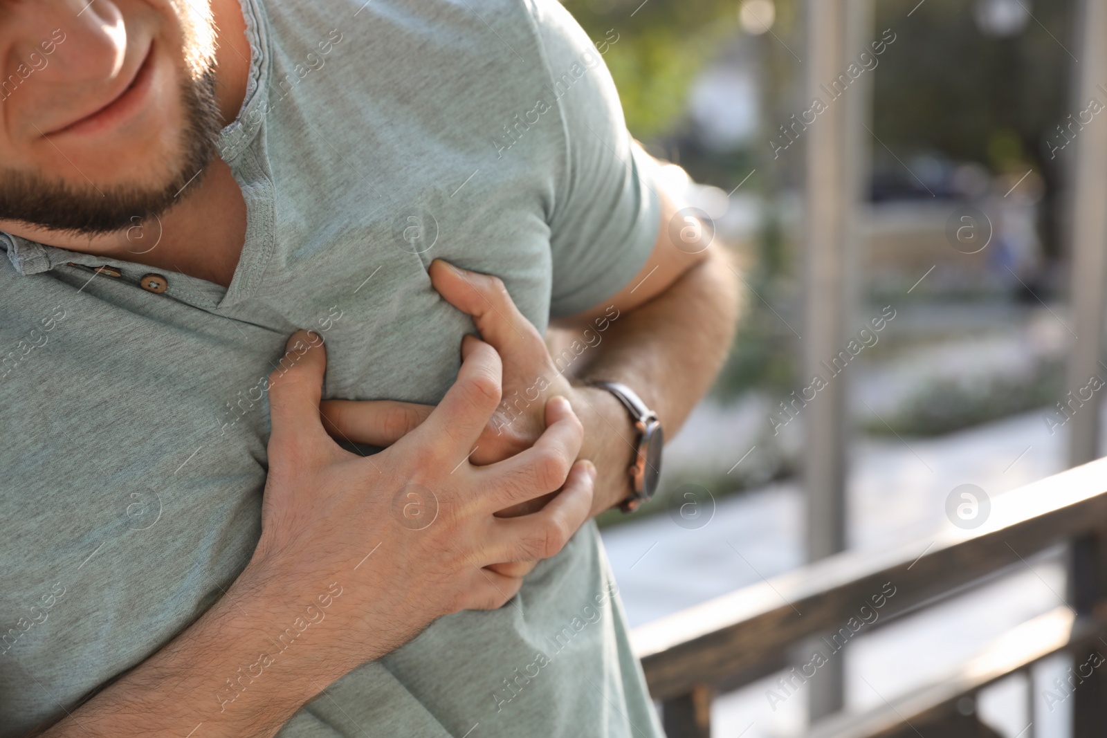 Photo of Man having heart attack outdoors, closeup view