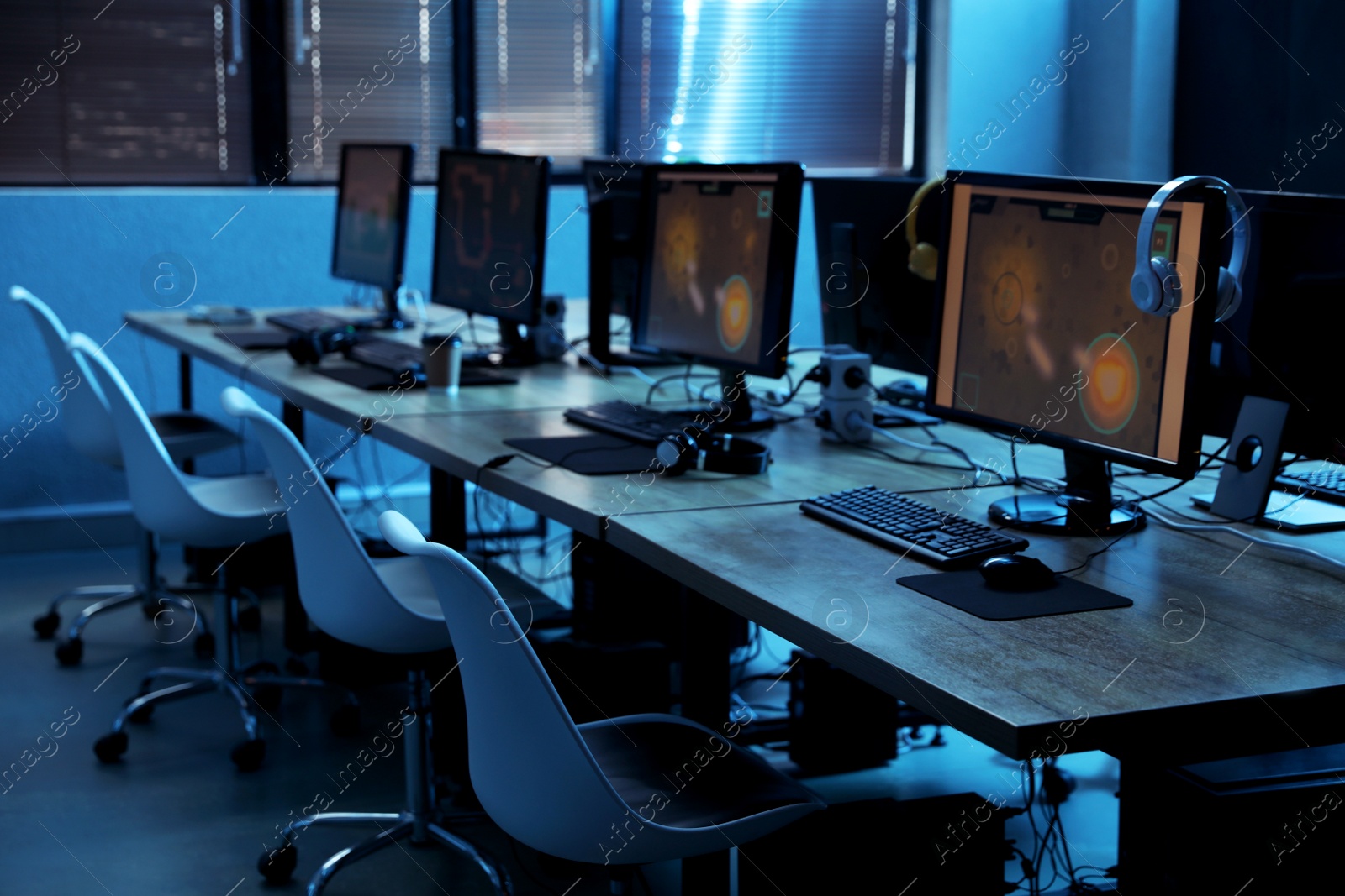 Photo of Internet cafe interior with modern computers. Video game tournament