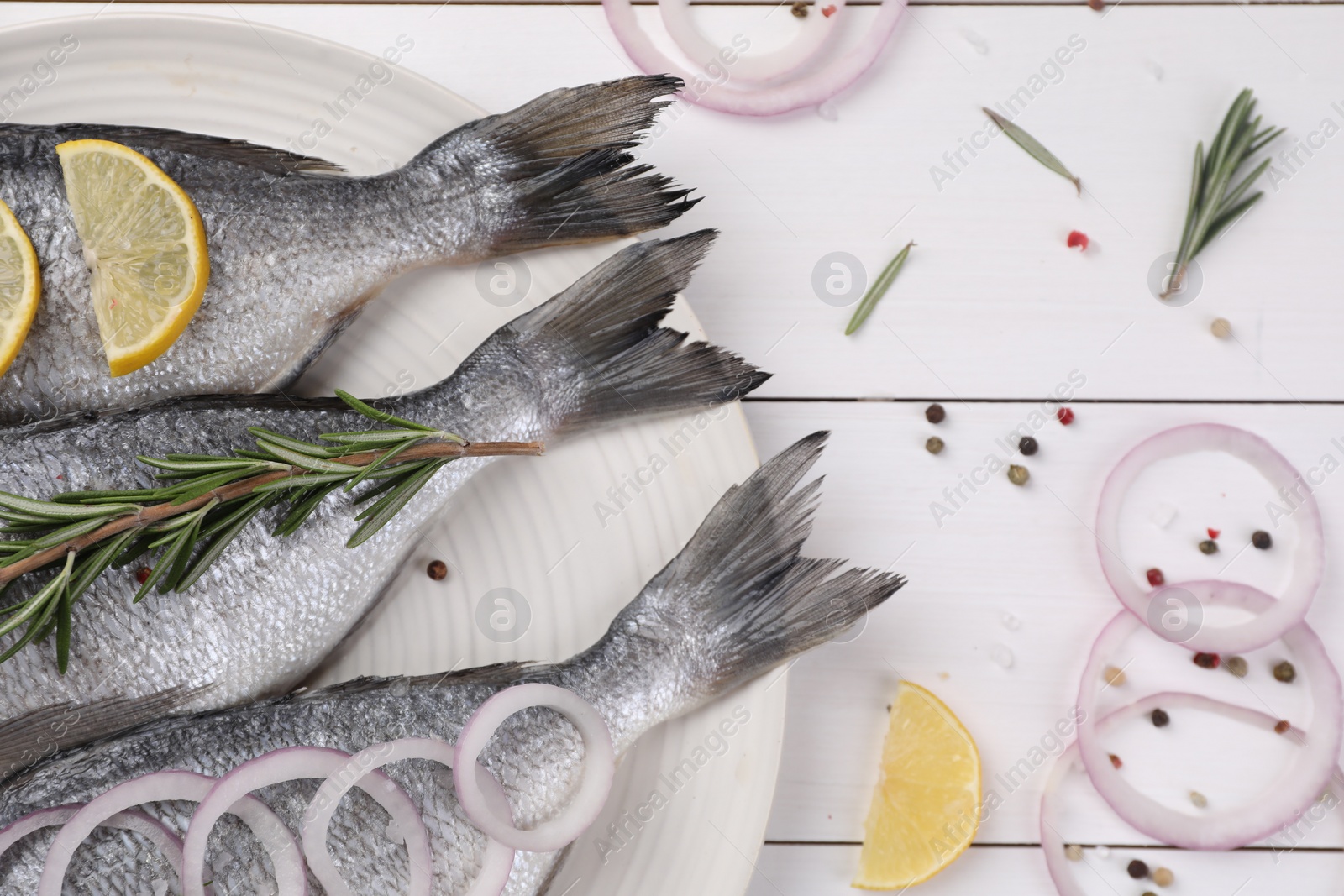 Photo of Flat lay composition with raw dorado fish and spices on white wooden table