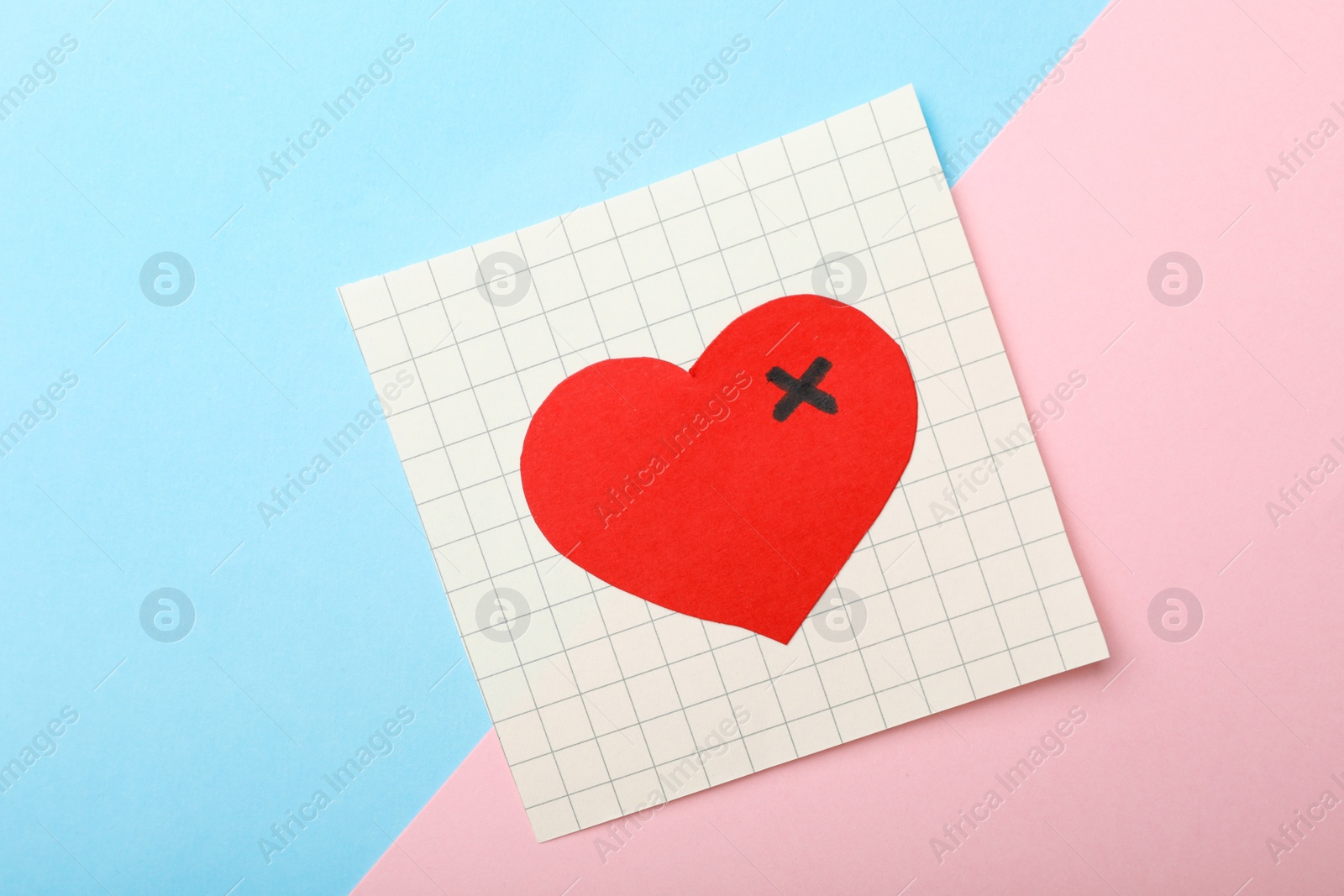 Photo of Paper with drawn heart on color background, top view. Relationship problems concept