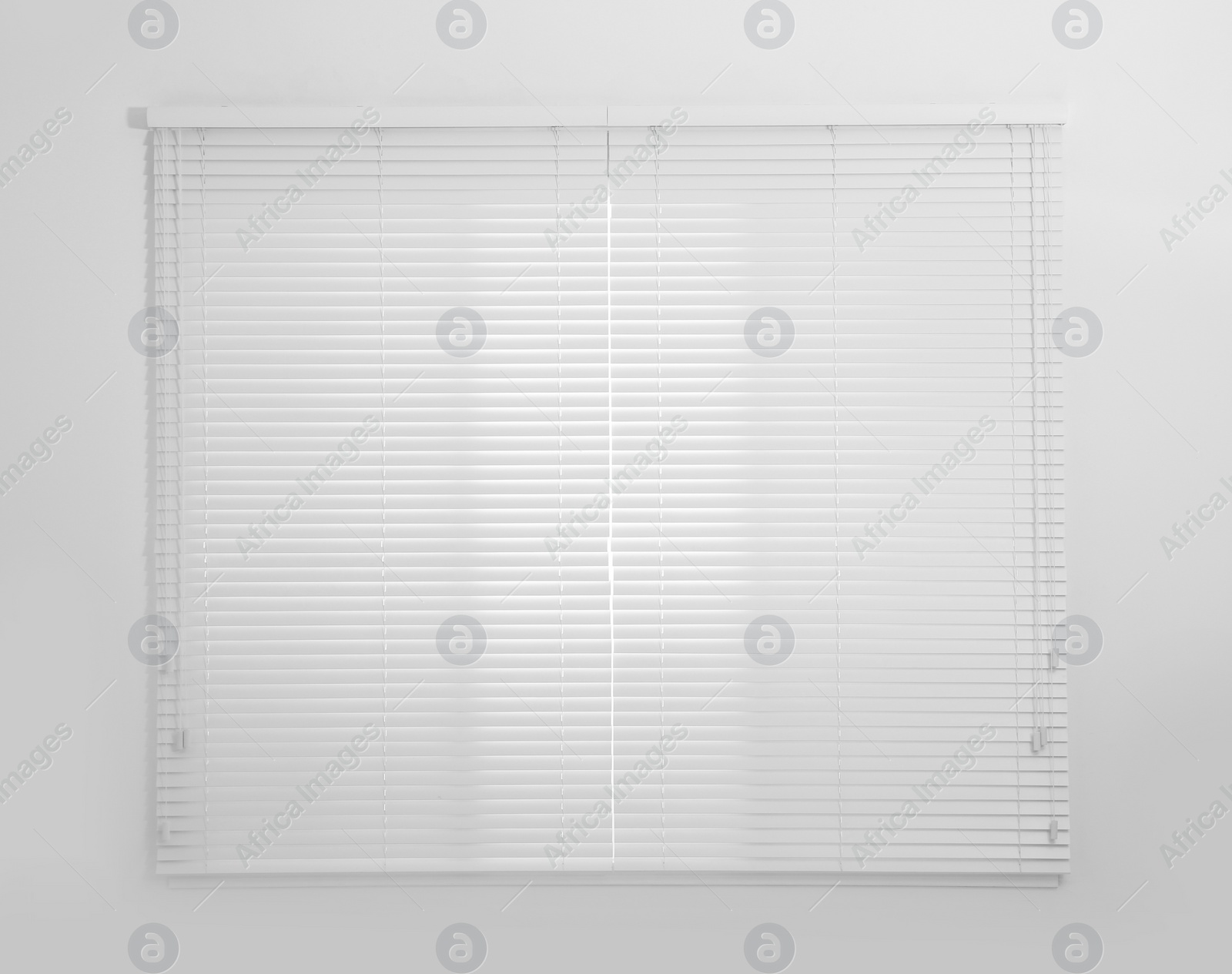 Photo of Window with white closed blinds in room
