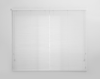 Photo of Window with white closed blinds in room