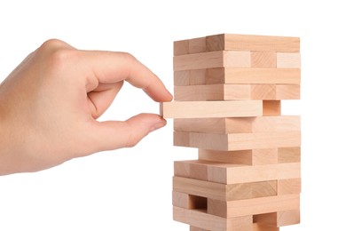 Photo of Playing Jenga. Man removing wooden block from tower on white background, closeup