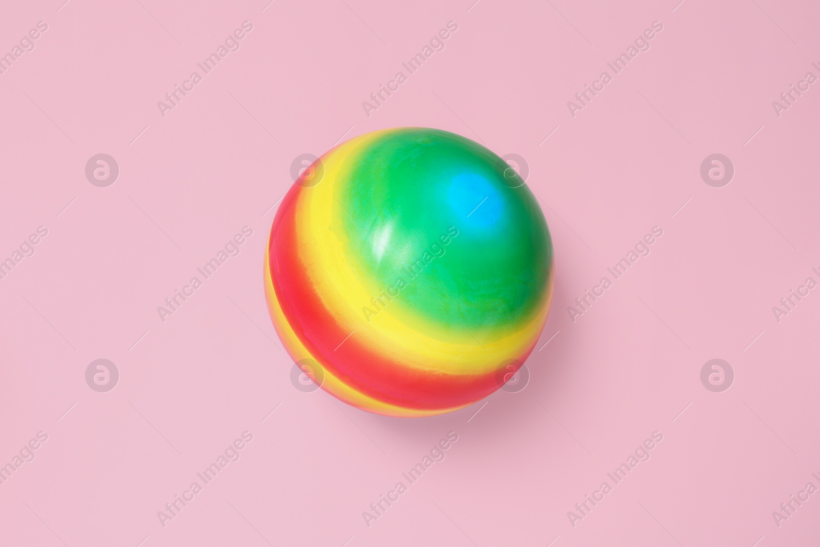 Photo of New bright kids' ball on pink background, top view