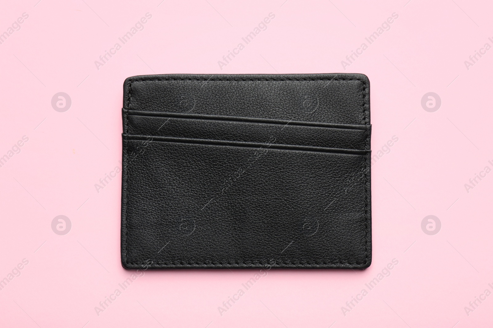 Photo of Empty leather card holder on pink background, top view