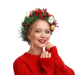 Beautiful young woman wearing Christmas wreath on white background