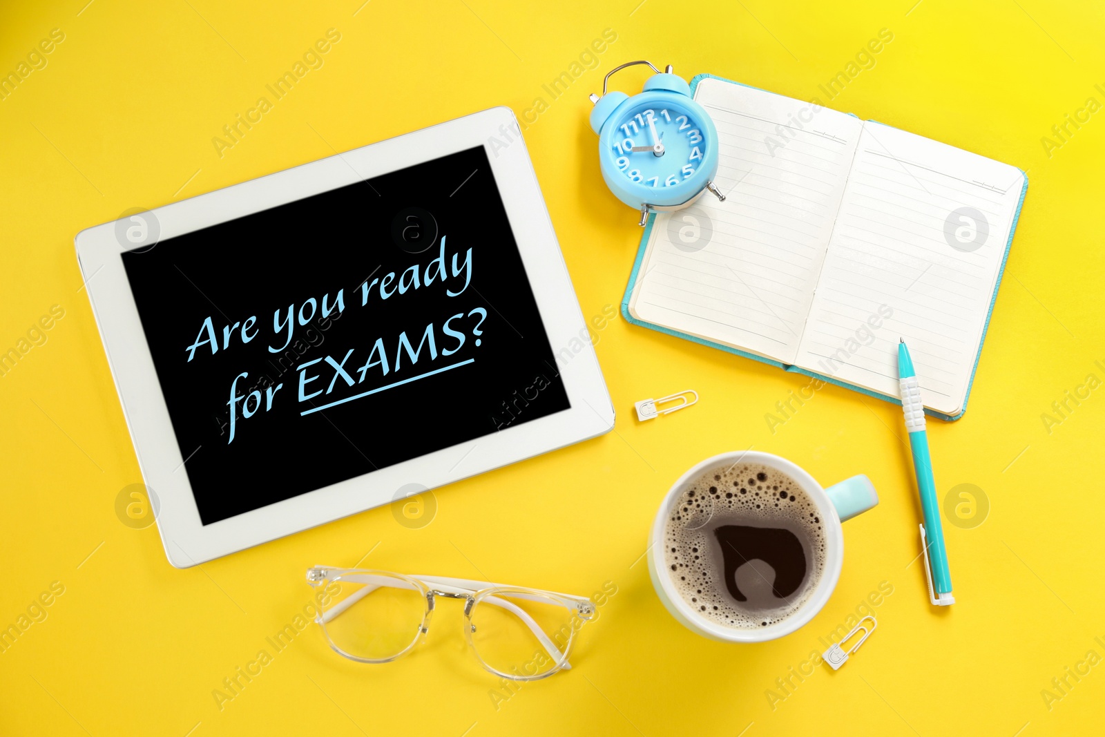 Image of Modern tablet with phrase ARE YOU READY FOR EXAMS on yellow background, flat lay