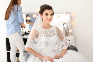 Beautiful young bride with makeup created by professional artist indoors