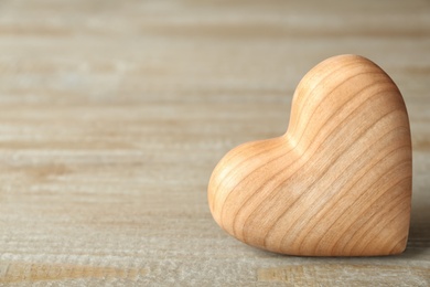 Photo of Decorative heart and space for text on wooden table, closeup. Valentine's Day