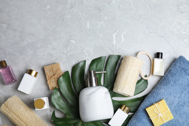 Photo of Flat lay composition with soap dispenser on grey marble background. Space for text
