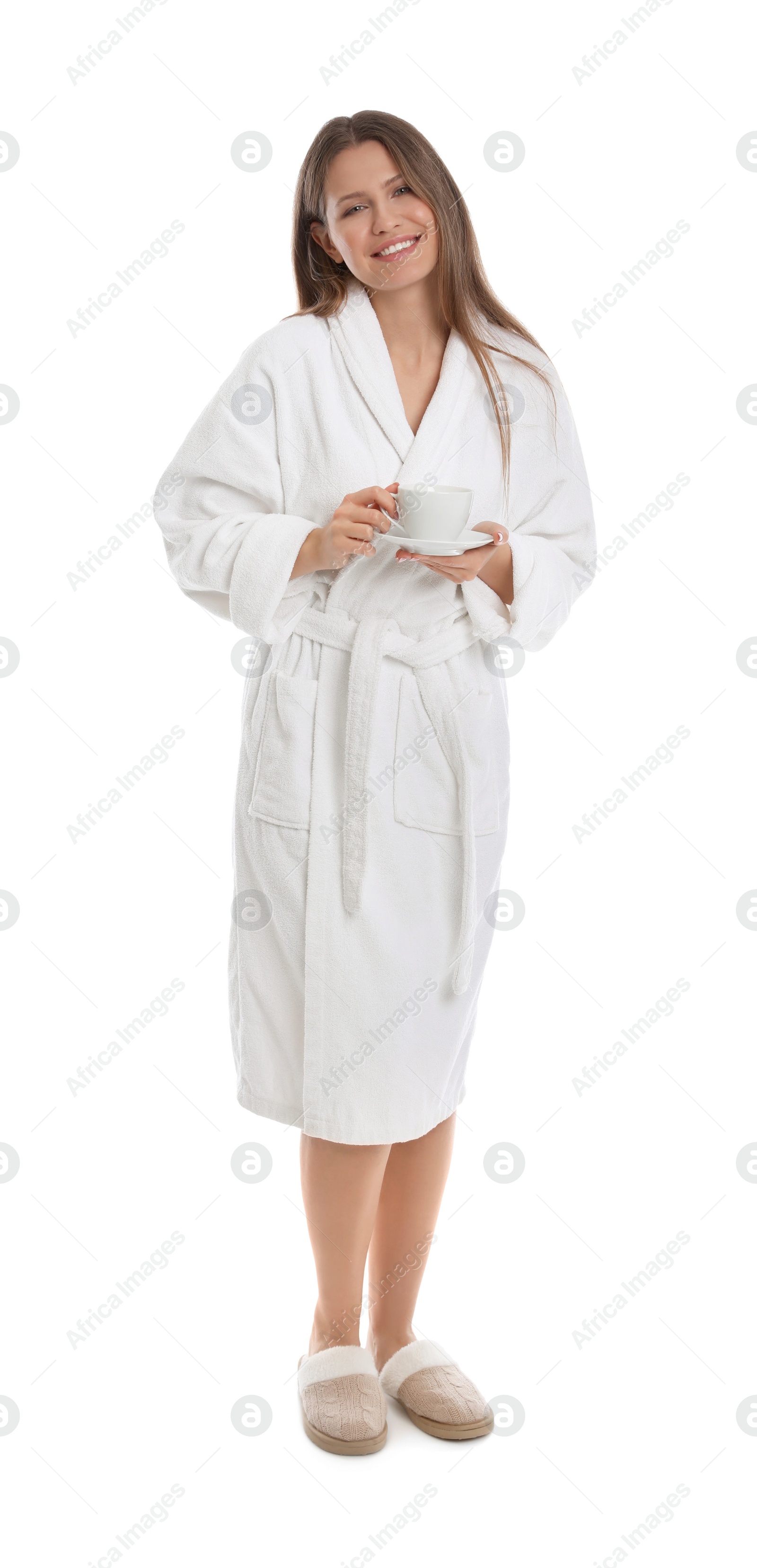 Photo of Young woman in bathrobe with cup of beverage on white background