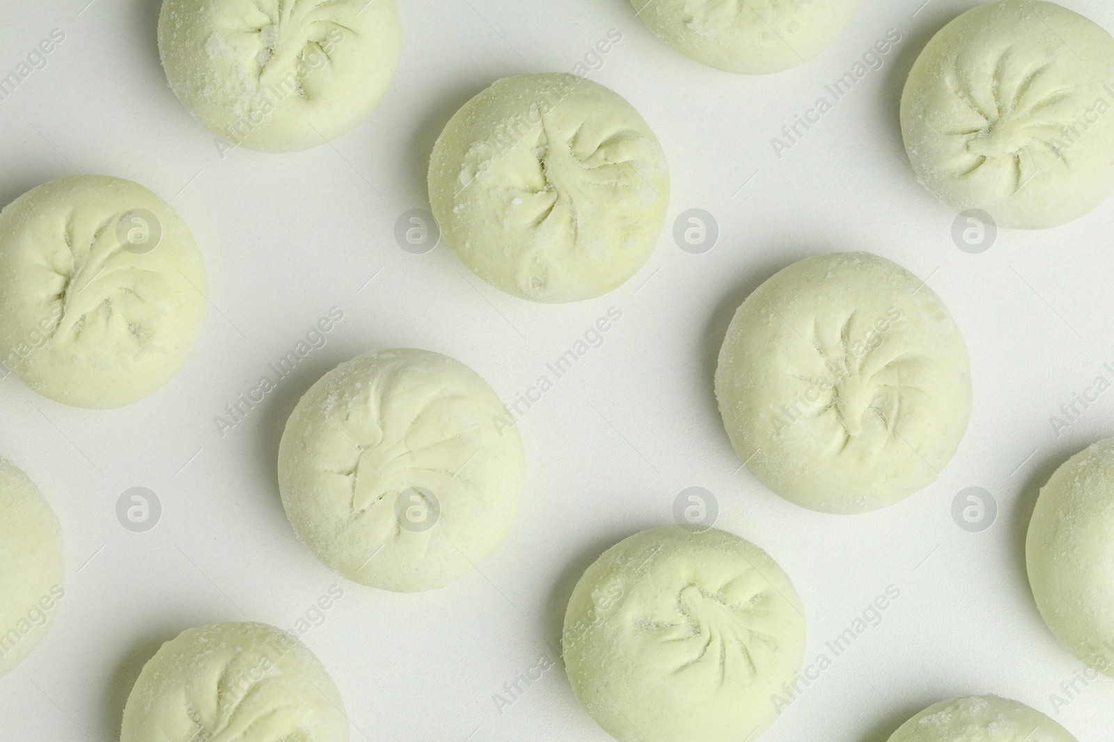 Photo of Composition with raw dumplings on white background, top view