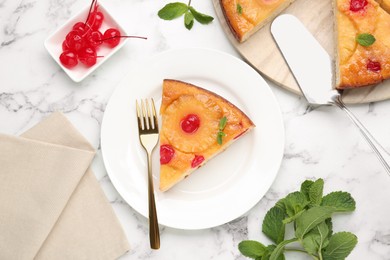 Photo of Delicious cut pineapple pie with cherry and mint on white marble table, flat lay