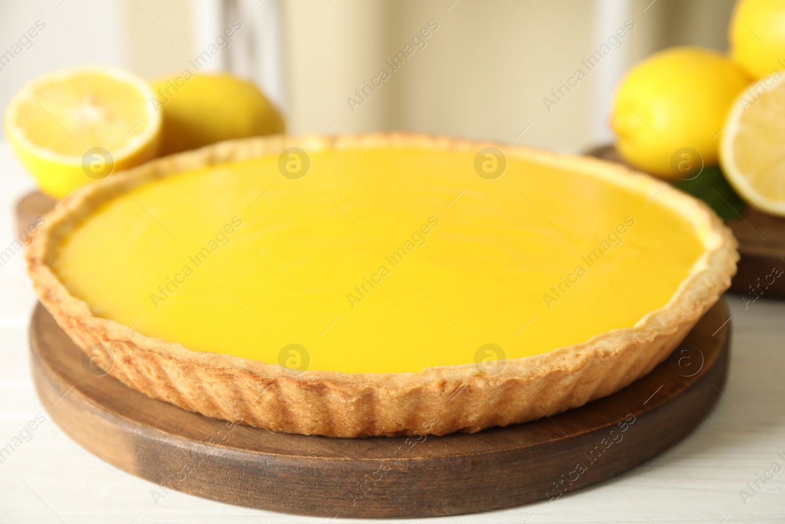 Photo of Delicious homemade lemon pie on white wooden table