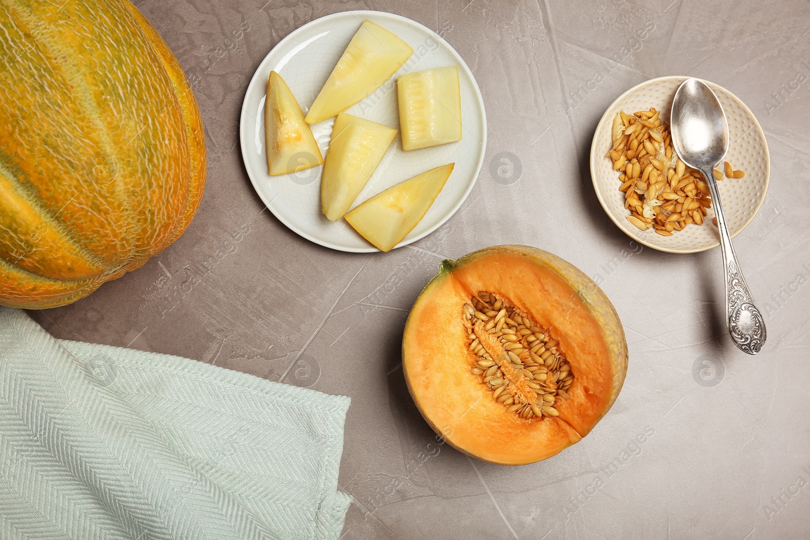 Photo of Flat lay composition with delicious cut melons on table