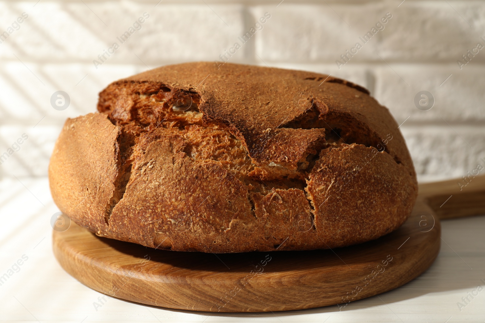 Photo of Freshly baked sourdough bread on white table