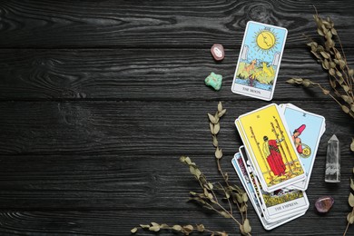 Flat lay composition with Moon and other tarot cards on black wooden table. Space for text