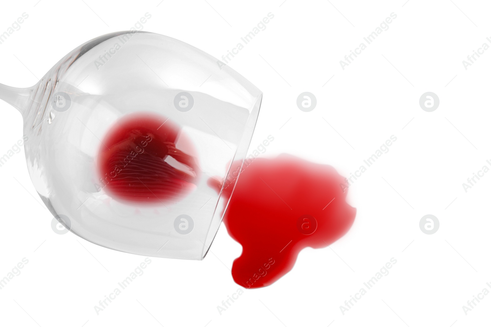 Photo of Transparent glass and spilled exquisite red wine on white background, top view