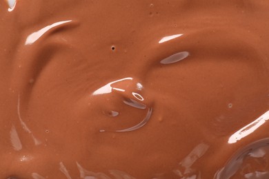 Texture of tasty melted milk chocolate as background