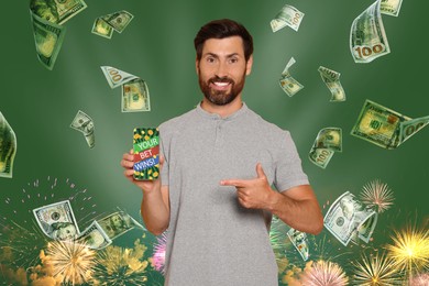Your Bet Wins! Happy man pointing at smartphone under money shower against green background with fireworks